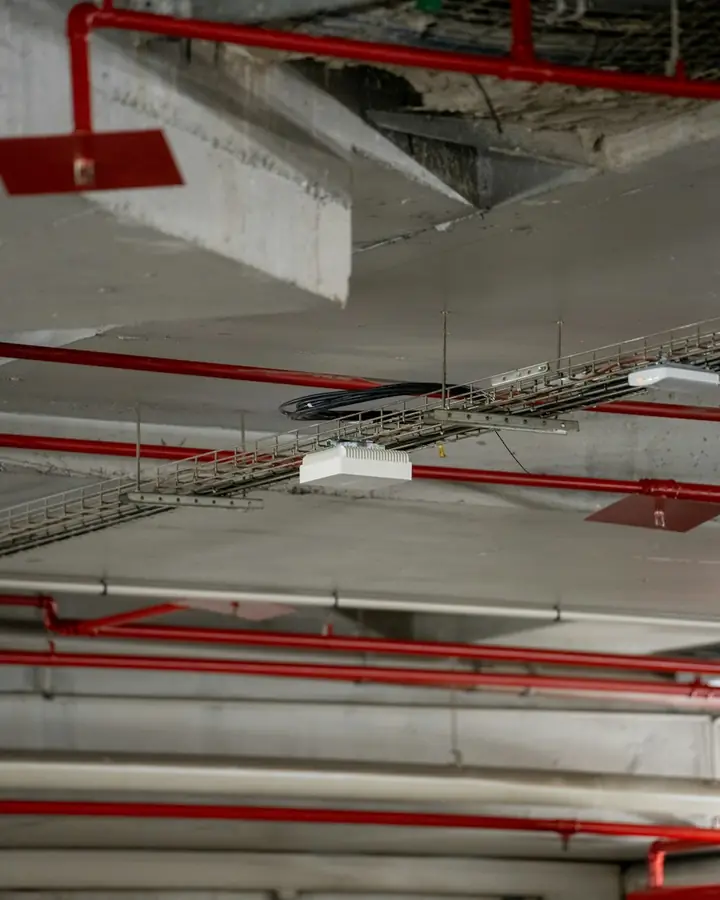Exposed commercial ceiling with conduit and cable tray
