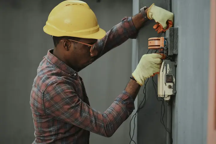 Electrician working on an exterior meter enclosure