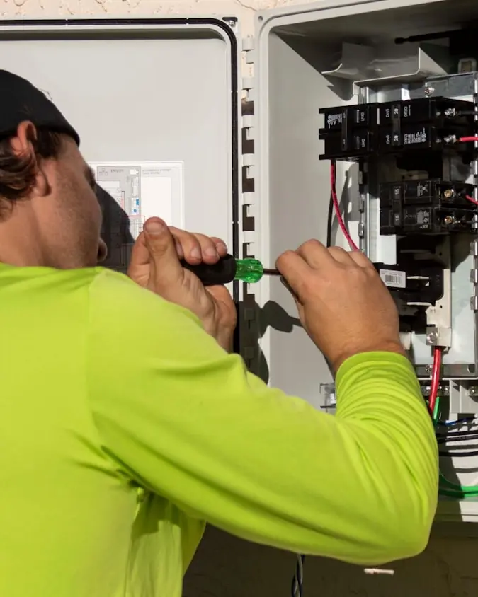 Electrician working inside a residential electrical enclosure
